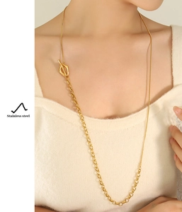 Detail of gold stainless steel necklace featuring mixed chain links and OT toggle clasp