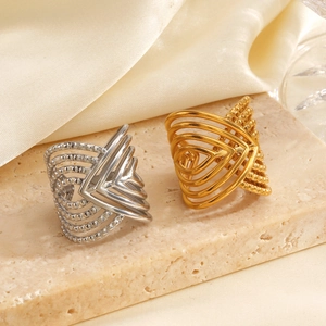 Exaggerated 18K gold and silver plated cross line open rings on stone and silk fabric