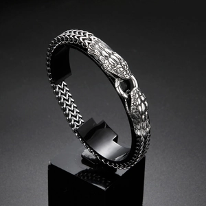 Détail d'un bracelet en acier inoxydable à double tête de serpent argentée sur un support
