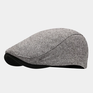 Detail of grey herringbone ivy cap featuring premium texture and black brim underside