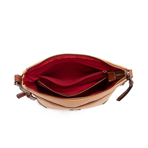 Top view of pebble leather bag interior showing red lining, zipper and compartments
