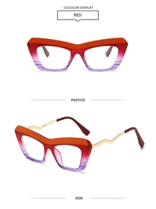 Detail of cat-eye frames with red gradient finish and golden wavy metal temples