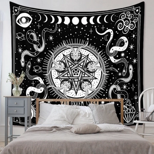 Detail of occult bohemian tapestry featuring pentagram and snake in a bedroom