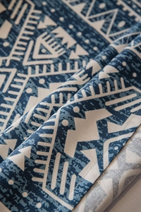 Close-up of blue geometric triangle print on high-quality linen cotton tablecloth fabric