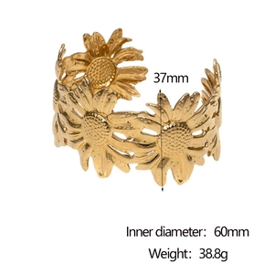 Detailed view showing a wide sunflower pattern gold bangle with 37mm height