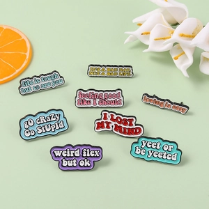Colorful enamel pins with inspirational quotes like life is tough but so are you