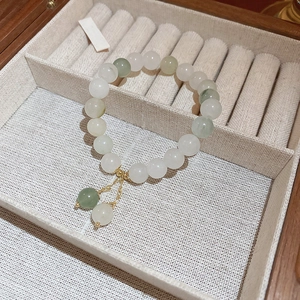 Detailed shot of irregular pearls and green jade beads bracelet in a wooden jewelry box