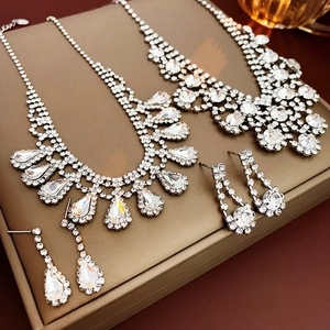 Detailed view of luxury geometric waterdrop rhinestone necklace and earrings set in gift box