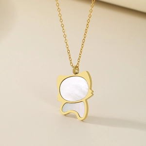 Close-up of a gold cat pendant featuring a white shell inlay on a delicate O-chain necklace