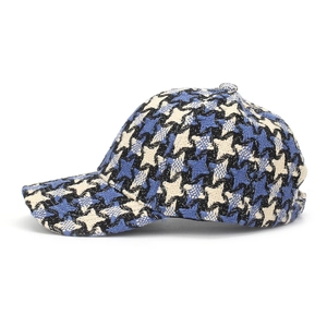 Detail of blue and black tweed plaid baseball cap showing premium woven texture and fibers