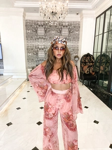 Detail of pink floral chiffon set with off-shoulder crop top and high-waist wide-leg pants