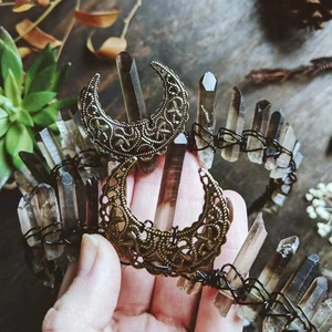 Macro shot of bronze hollow filigree crescent moon pieces for DIY crystal crown crafting