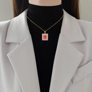 Titanium steel necklace with pink rectangular pendant and red heart worn by a model
