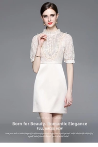 Detailed view of high-neck lace stitching and heavy beadwork on the dress sleeve