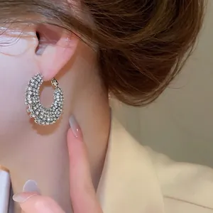 Elegant silver-plated C-shaped hoop earrings with sparkling pavé cubic zirconia inlay