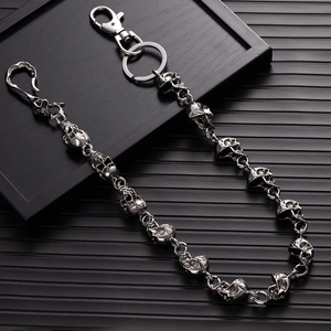 Detail of punk style silver skull chain link with spring clasp on black background