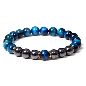 Macro shot of 8mm blue tiger eye beads and black magnetic stones with gold spacers