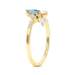 Detailed side view of a gold ring featuring a light blue square gemstone and white diamonds