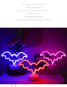 Three LED bat-shaped neon lights in blue, pink, and orange with white circular bases