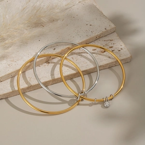 Three-piece minimalist layered bracelets set in gold and silver with zircon pendant
