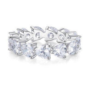 Macro shot of silver heart-shaped eternity ring band with pavé set cubic zirconia