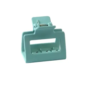 Detail of mint green matte square hair claw clip with sturdy metal spring mechanism