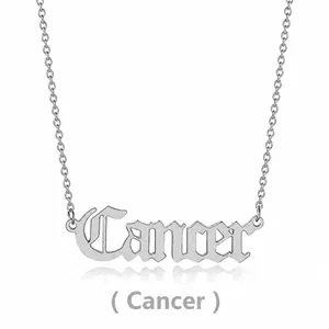 Detailed shot of silver titanium steel Cancer zodiac pendant on a thin link necklace