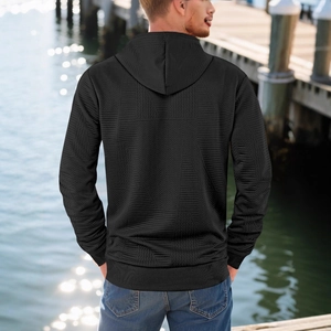 Men's black relaxed-fit hoodie with geometric jacquard texture and ribbed cuffs