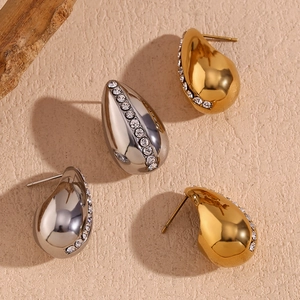Detail of 18K gold plated teardrop stud earrings with micro-set rhinestones and polished finish