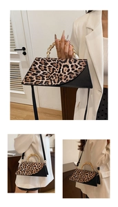 Detail showing the leopard print trapezoid handbag with luxury gold metallic twisted handle