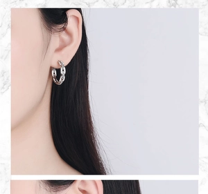 Detailed view of silver chain earrings with pavé cubic zirconia worn by a model