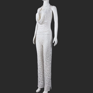 Detailed side view of white lace halter jumpsuit with elegant backless floral pattern