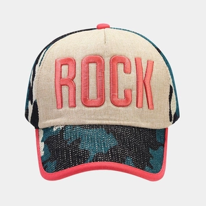 Detailed view of pink ROCK embroidery and blue camo knit texture on a baseball cap