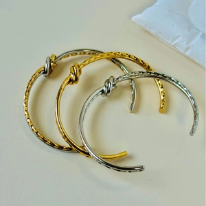 Minimalist stainless steel twisted knot open cuff bracelet in gold and silver finish