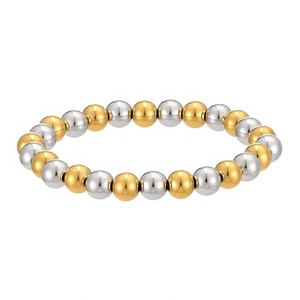 Detailed view of two-tone gold and silver stainless steel beaded elastic bracelet