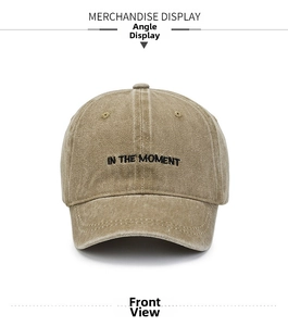 Detailed macro view of washed khaki cotton cap with In The Moment embroidery texture