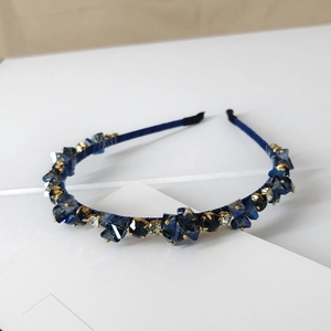 Macro shot of dark blue crystal headband with hand-set stones and velvet lining