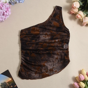 Close-up of brown floral flocking and gathered ruching on asymmetrical tank top