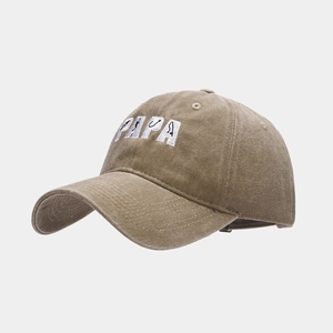 Close-up of PAPA 3D embroidery with fishing hook design on washed khaki canvas baseball cap