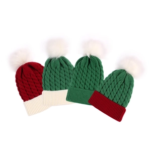 Detailed view of knitted textures and fluffy pom-poms on colorful kids' Christmas hats