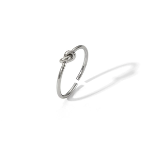 Macro shot of minimalist knotted stainless steel open ring with adjustable band in silver