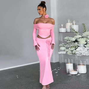 Detail of pink ribbed knit set showing 3D floral neck accessory and long sleeve top