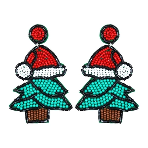 Detailed close-up of handmade beaded Christmas tree earrings with colorful seed beads
