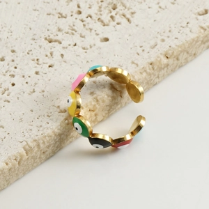 Macro shot of 18K gold plated stainless steel evil eye open ring on stone base
