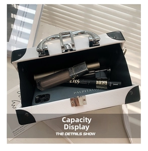 Macro view of white box bag interior showing capacity for smartphone and cosmetics