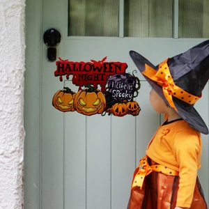 Close-up of Halloween pumpkin and bat stickers on a door for holiday home decoration