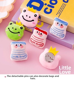 Detailed view of cute plush badges with crown frog and health drink embroidery art