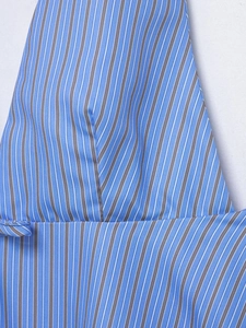 Close-up of blue and white vertical striped woven fabric texture and stitching detail