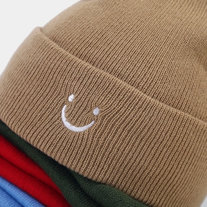 Beanie with smiley embroidery in various colors including khaki, red and blue