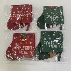 Macro shot of red and green cloth Christmas stockings in individual plastic packaging